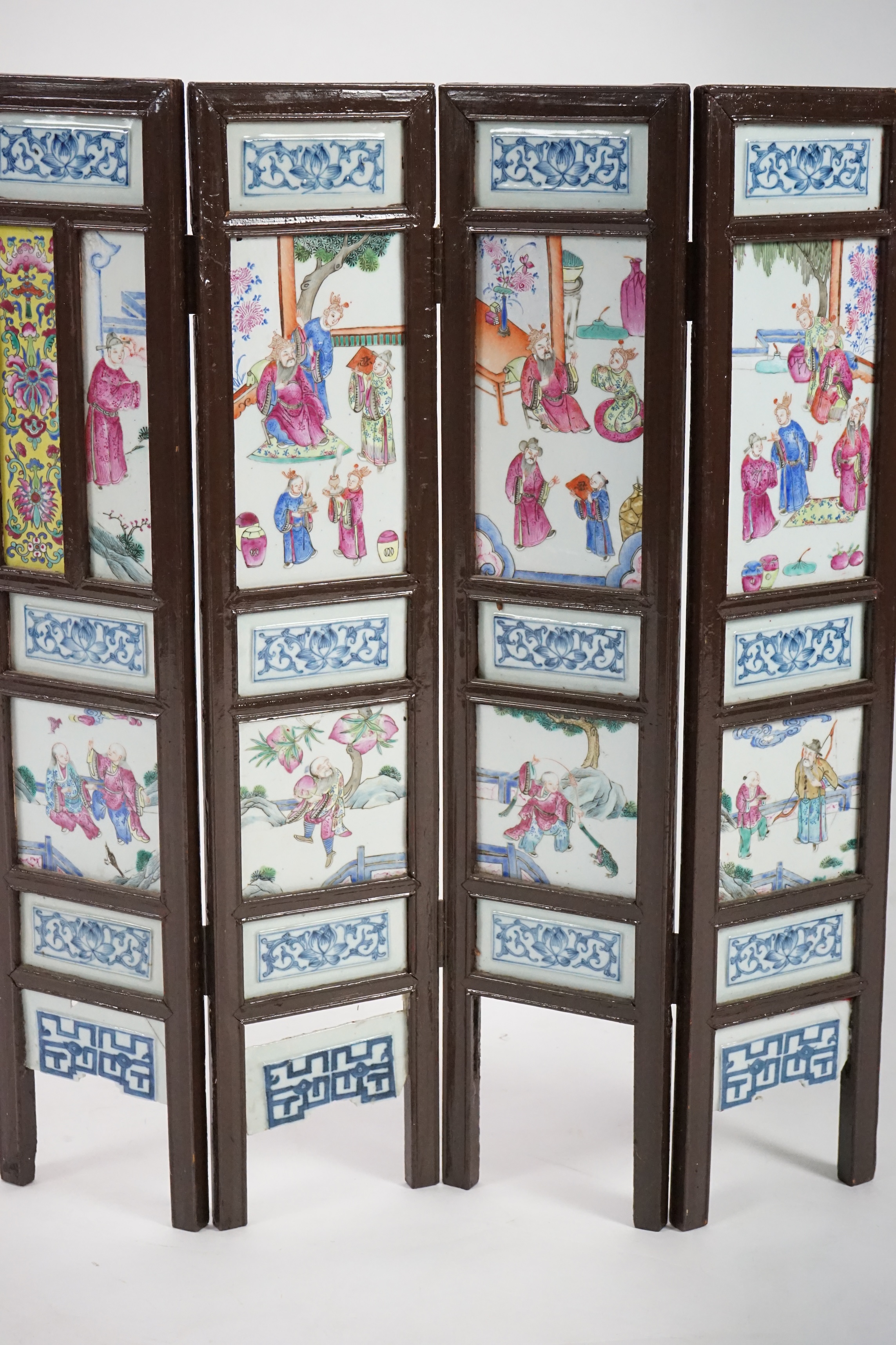 A Chinese wood framed and porcelain mounted low screen, late 19th century